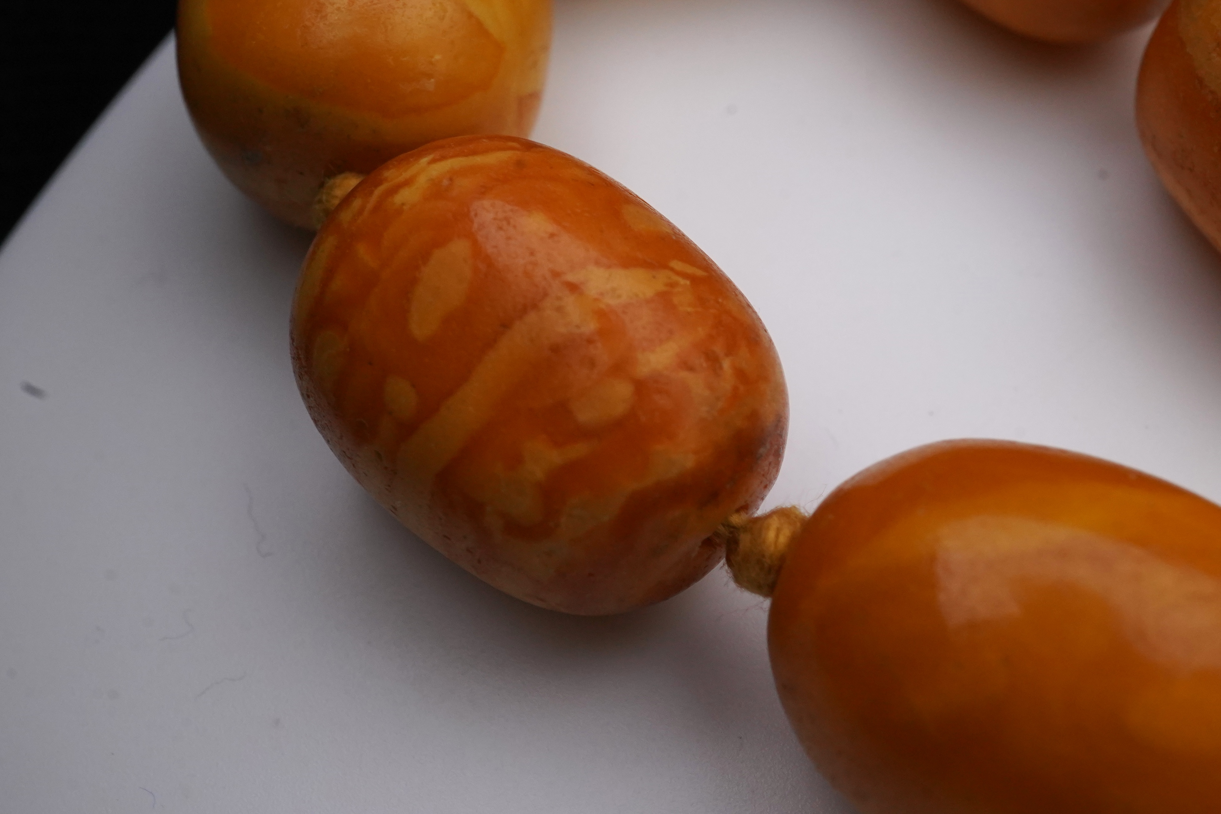 A single strand graduated oval amber bead necklace